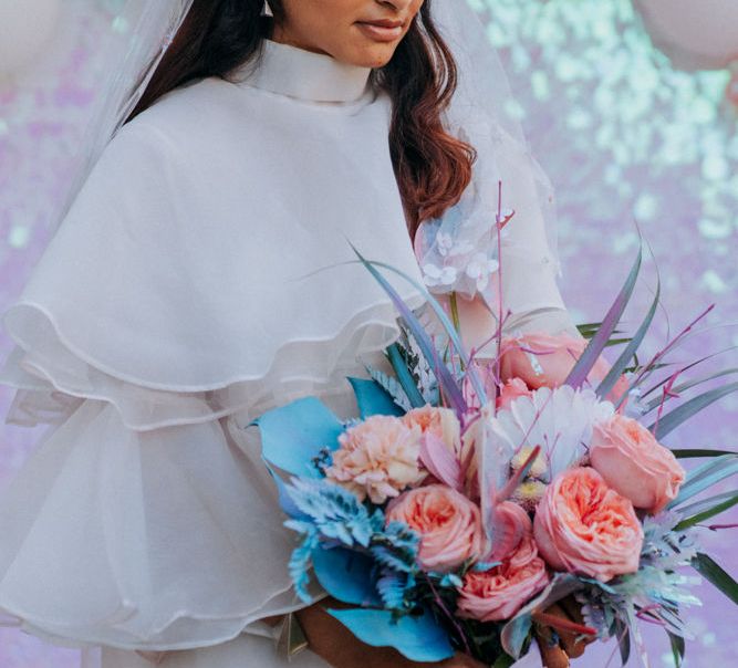 Bride holding her holographic pastel wedding bouquet 