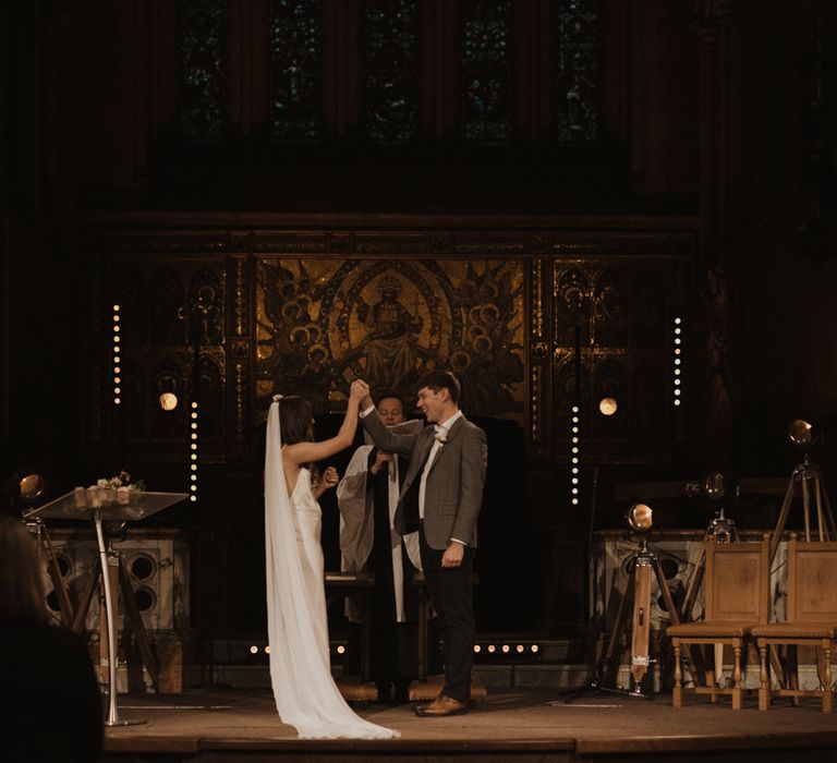 Bride and groom exchanging vows at their Holy Trinity Brompton Church wedding ceremony 