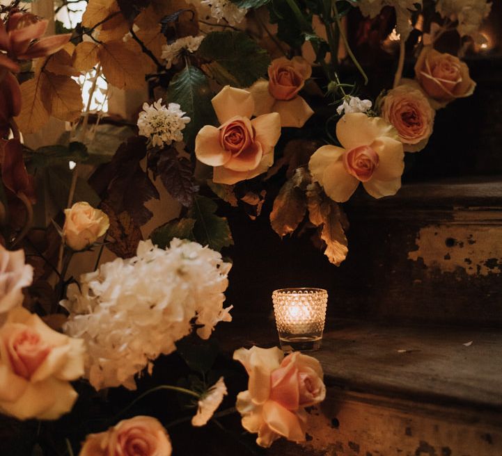 Floral candle display for autumn wedding at Reymerston Hall