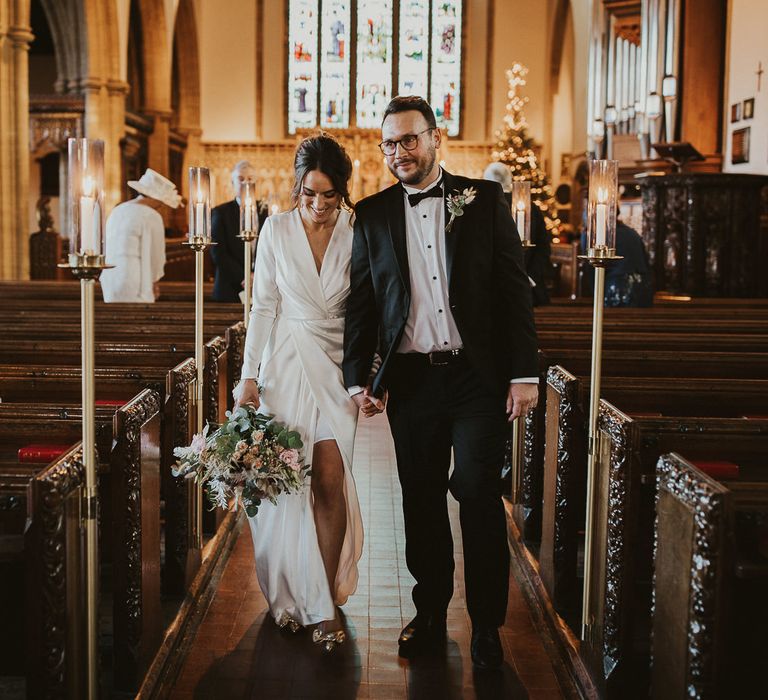 Bride & groom walk down the aisle together after wedding ceremony at Sherborne School