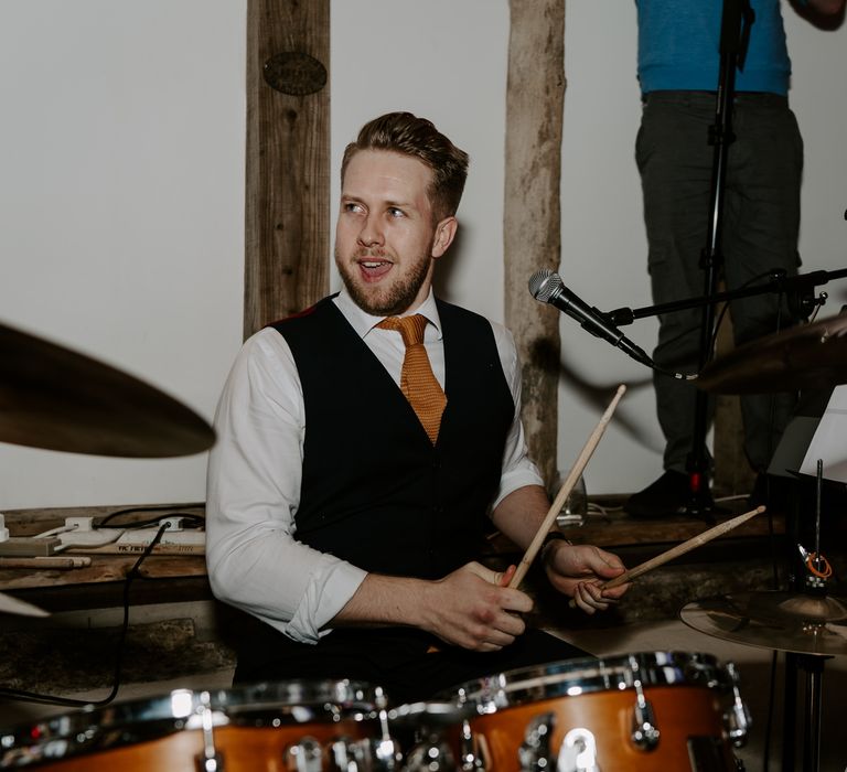 Drummer groom performing with the wedding band 