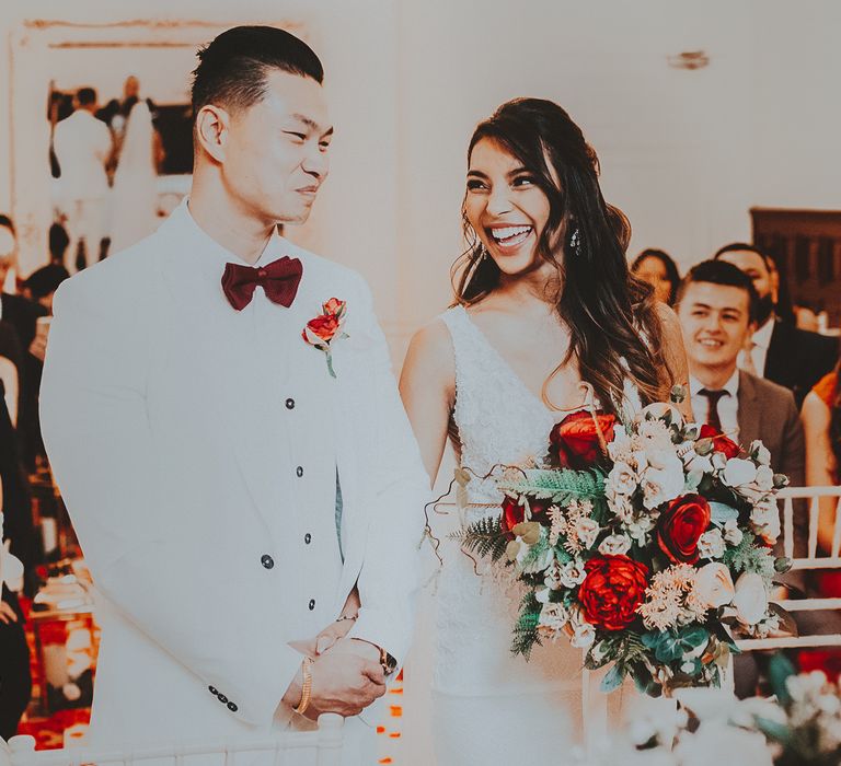 Bride & groom look at one another during wedding ceremony