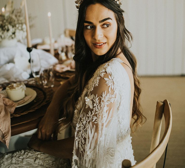 Bride in a lace wedding dress with watteau sleeve and leaf headdress 