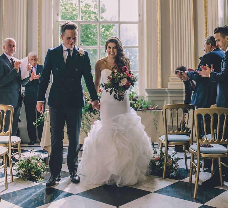 Bride and groom walking down the aisle at Orleans House Gallery wedding 