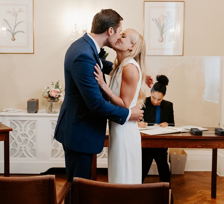 Bride & groom kiss during ceremony at Chelsea Old Town Hall