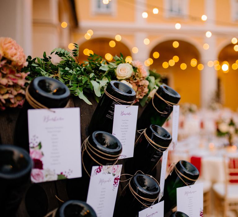 Red wine rack table plan for an outdoor Italian wedding