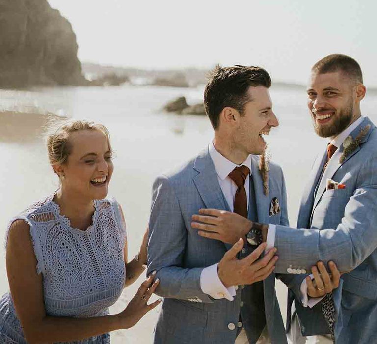 Groom with wedding guests all wearing blue