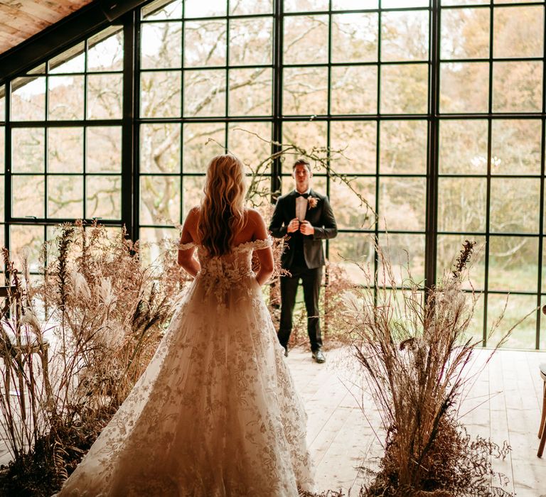 Bride in a 3D lace wedding dress walking down the aisle decorated in dried flowers