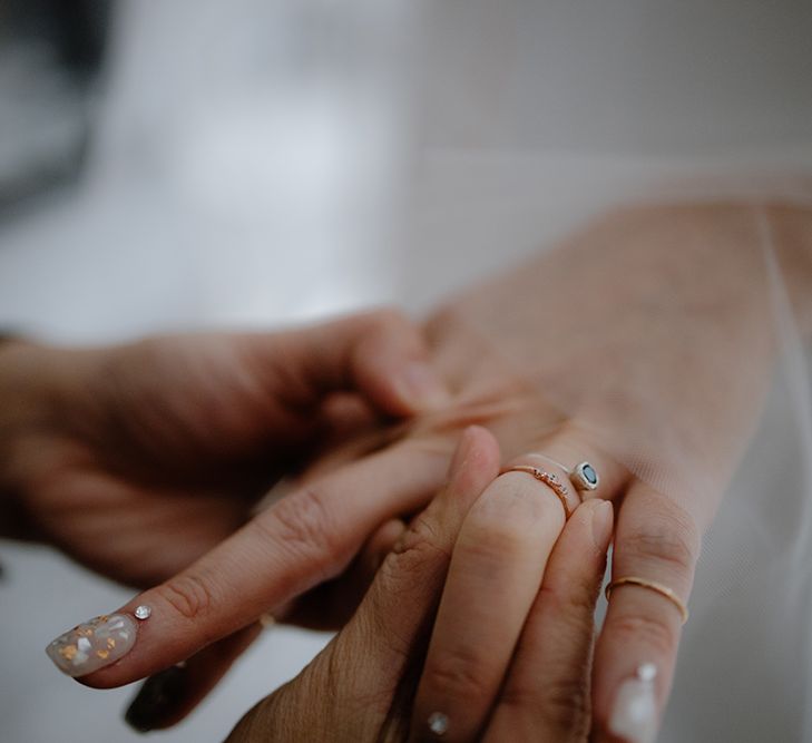 Stylish bridal nail art and delicate wedding rings 