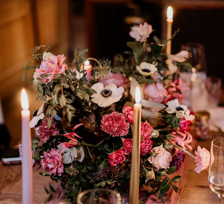 Pastel pink and red floral decoration lines table with candles