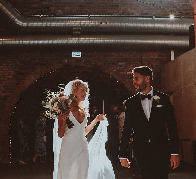 Bride in a Dove Grace Loves Lace satin slip wedding dress and groom in a tuxedo at Gas Street Church wedding ceremony 