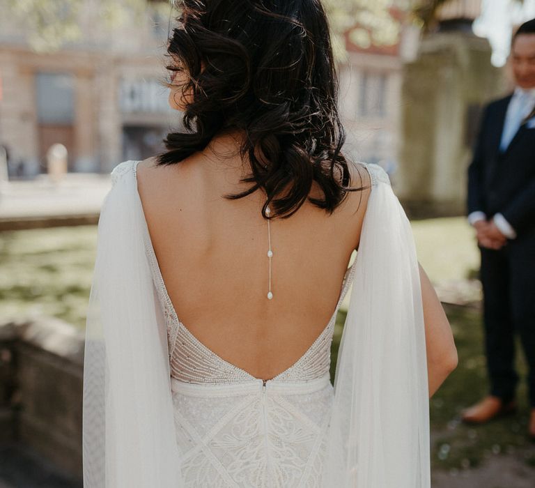 Plunge open back detail on Eliza Jane Howell wedding dress with veil cape