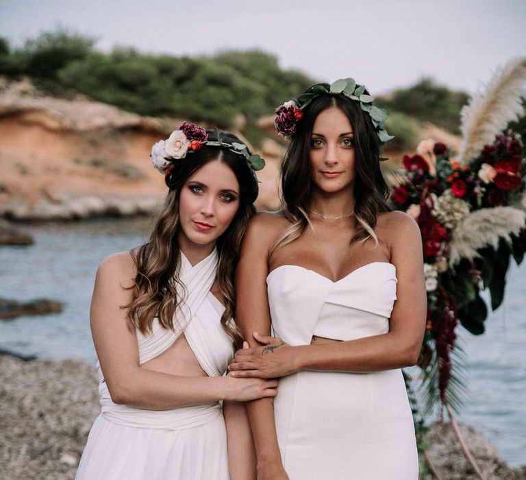 Two brides on the beach in Ibiza wearing Jarlo London and Kate's Dresses wedding gowns