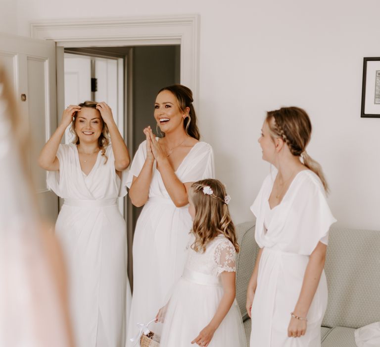 Bridal party see reveal of the bride for the first time on her wedding day