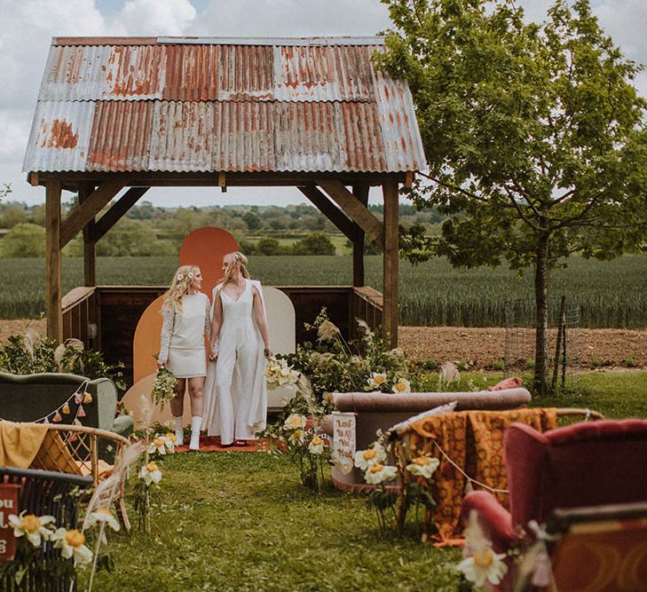 Outdoor wedding at Huntsmill Farm in Buckinghamshire with sixties wedding decor including bold colours, quirky details and wildflowers