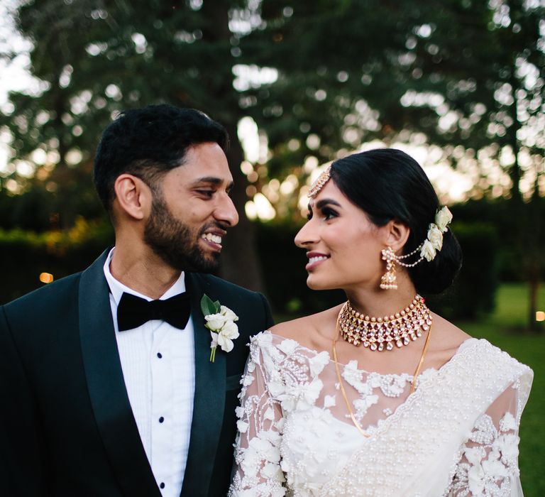 Bride & groom look lovingly at one another on their wedding day