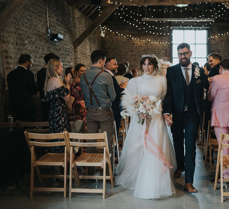 Bride & groom walk down the aisle after handfasting wedding ceremony