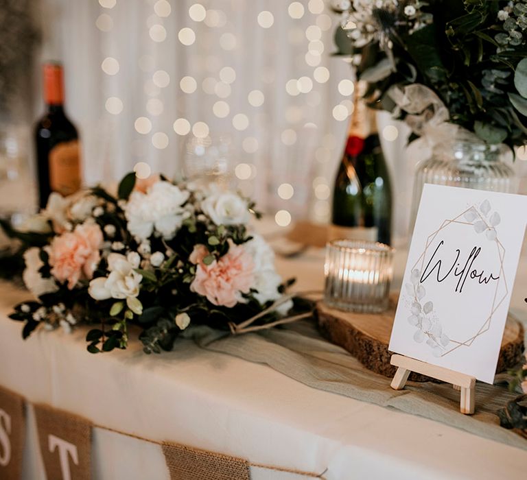 Pink and white wedding flower table decor with table numbers