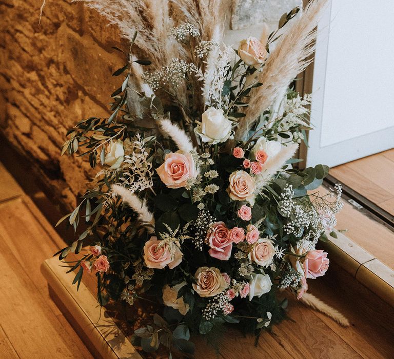 Beautiful pink wedding flowers with pampas grass