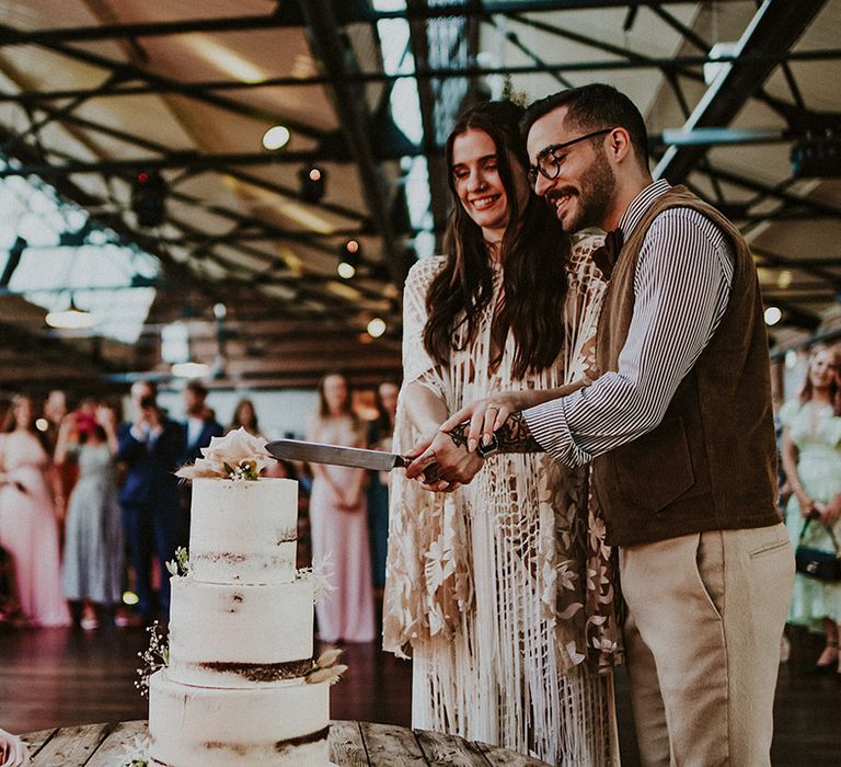 Bride & groom cut their wedding cake on the morning of their wedding day