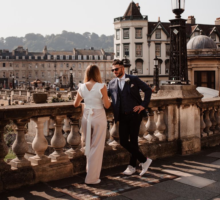 Micro wedding in Bath with bride in a white and pink jumpsuit and groom in a shoelace tie 