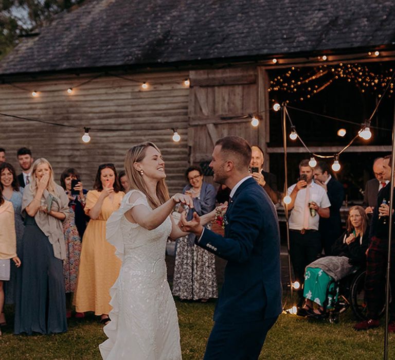 Rustic barn wedding with bride in a sparkly Eliza Jane Howell wedding dress at outdoor first dance 