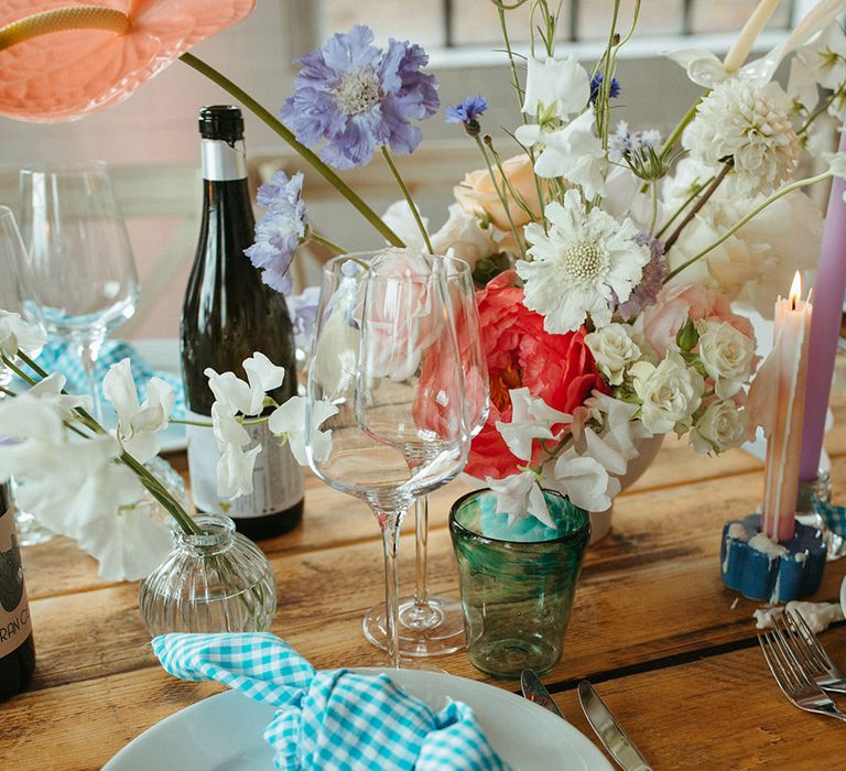 Purple place name card with gingham napkins and pastel wedding flowers 