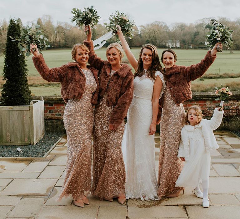 A Christmas wedding with the bridesmaid in embellished sequin dresses and fur coats 