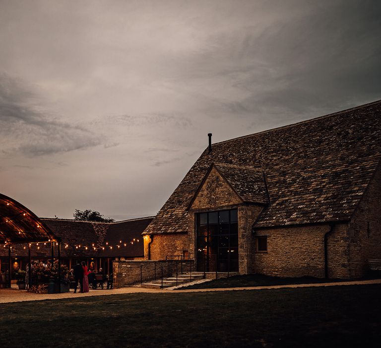 Old Gore Barn wedding venue lit up for the evening 