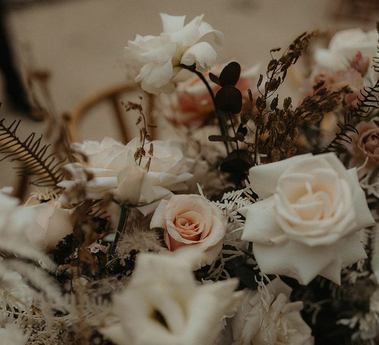 Pale wedding florals complete with pampas grass and green foliage 