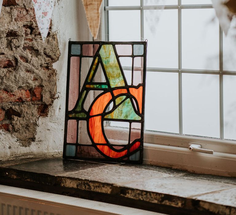 A DIY stained glass piece created by the bride's father for the wedding 