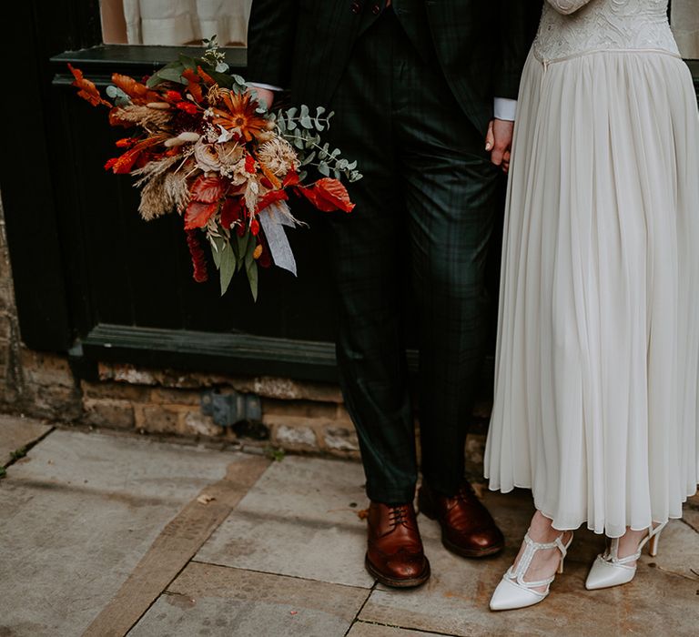 Bride's satin-look closed toe heels and groom's brown leather brogues 