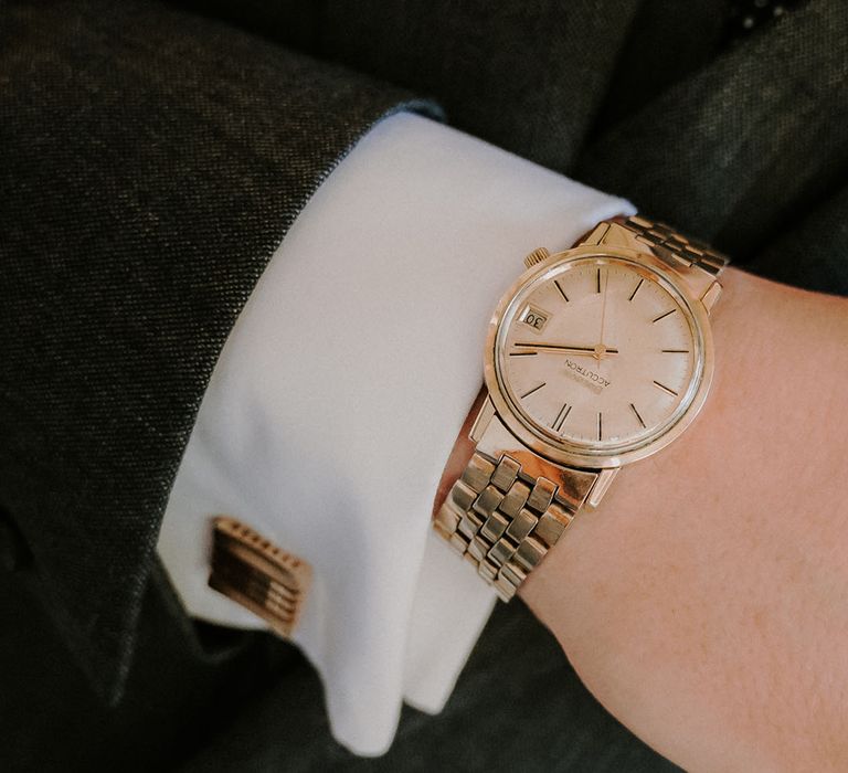 Groom in gold accessories and jewellery with gold cufflink and watch 