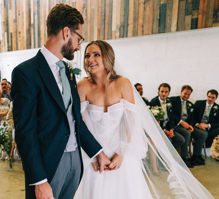 Groom in traditional morning suit for the barn wedding in Cambridgeshire with the bride in whimsical tulle bridal gown 