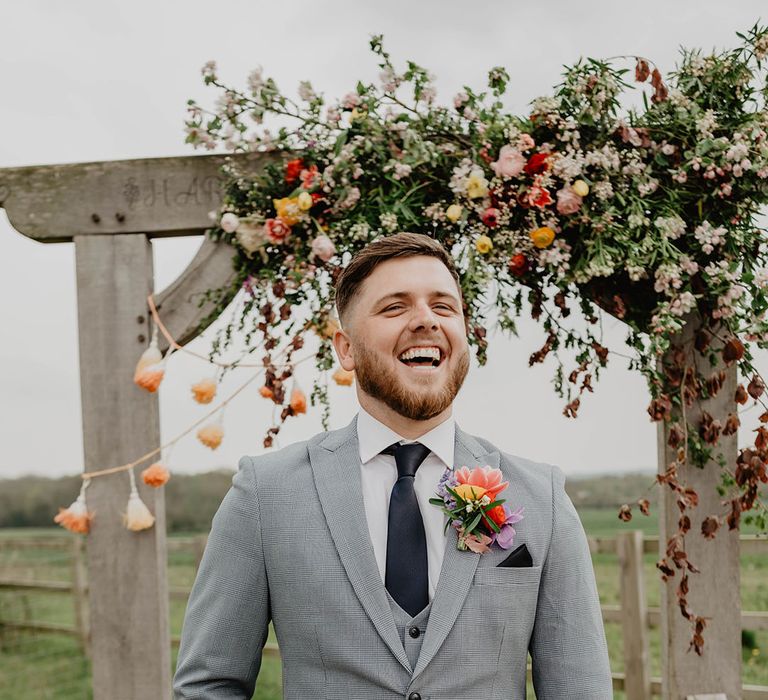 Groom in grey and black three piece suit for boho festival wedding at the outdoor wedding venue in the East Midlands 