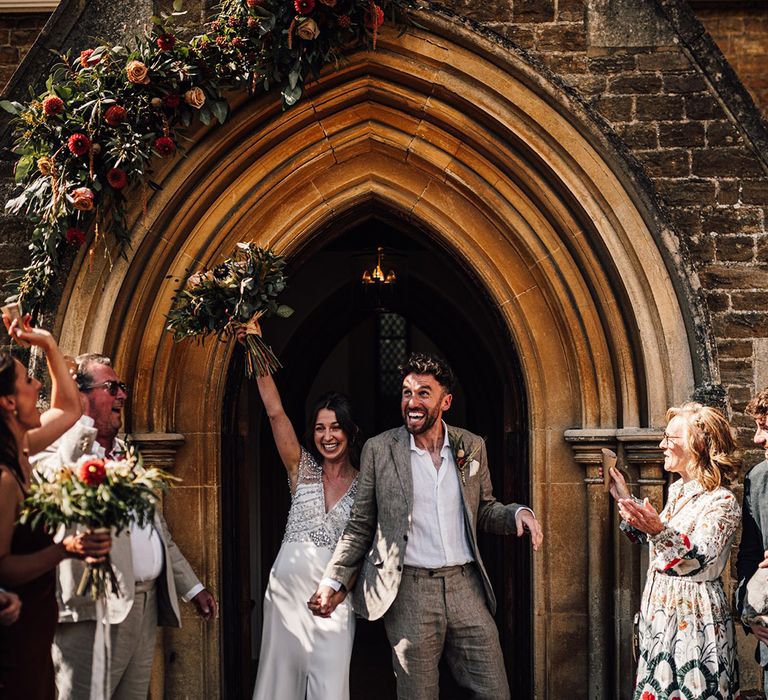 Confetti exit from traditional church ceremony for bride and groom 