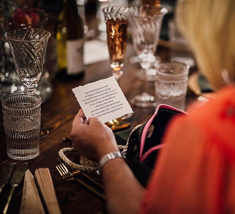 Guests reading personalised wedding favour notes 