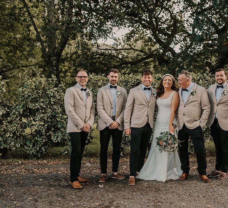 Groomsmen in beige suits at Chyara wedding in Cornwall with rustic luxe styling 