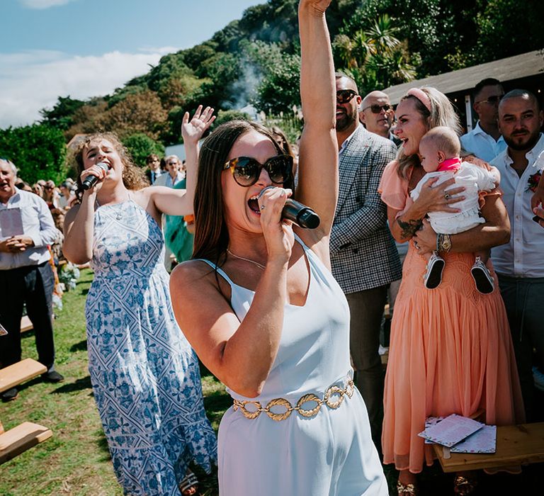 Wedding singers perform a surprise song during the outdoor wedding ceremony 