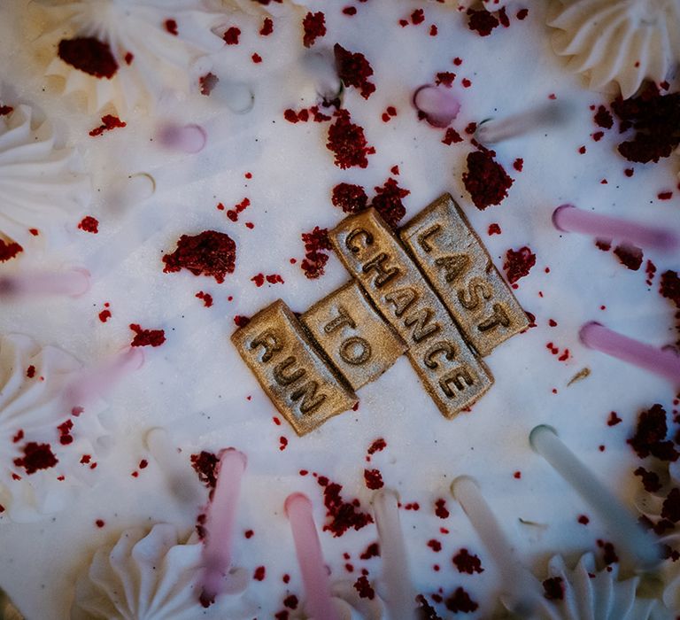 Wedding cake decorations reading 'one last chance to run' 