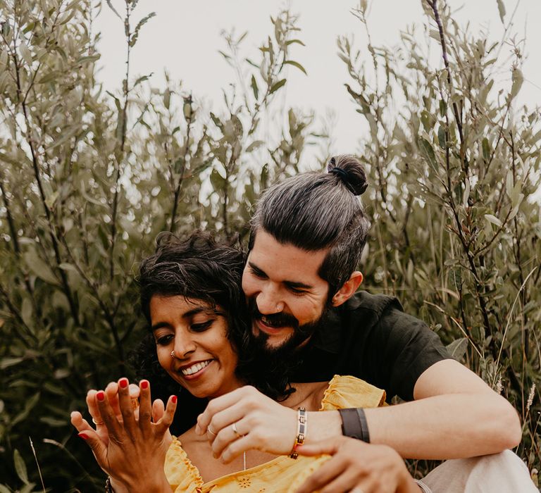 Bride and groom laughing at beach elopement 