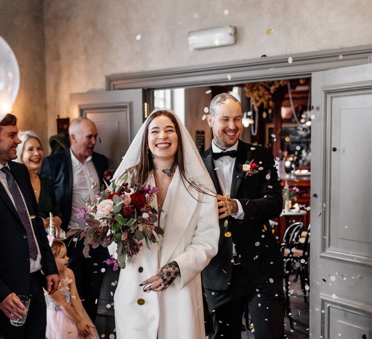 Bride and groom entering their Brighton micro wedding reception 