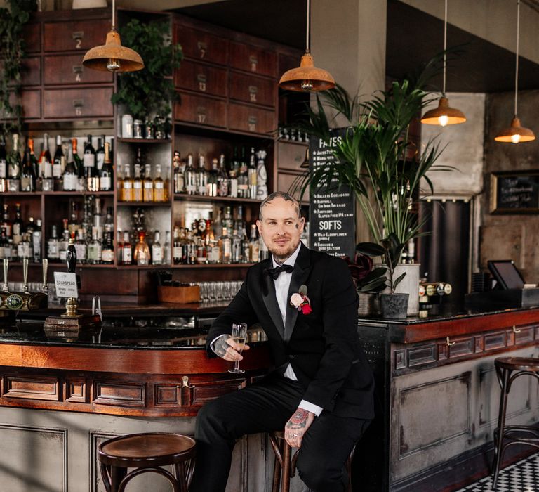 Stylish groom in tuxedo at micro wedding 