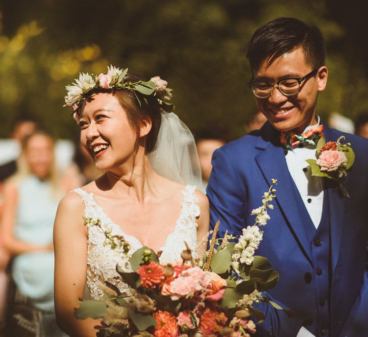 Bride in coral flower crown smiling during the intimate wedding ceremony 