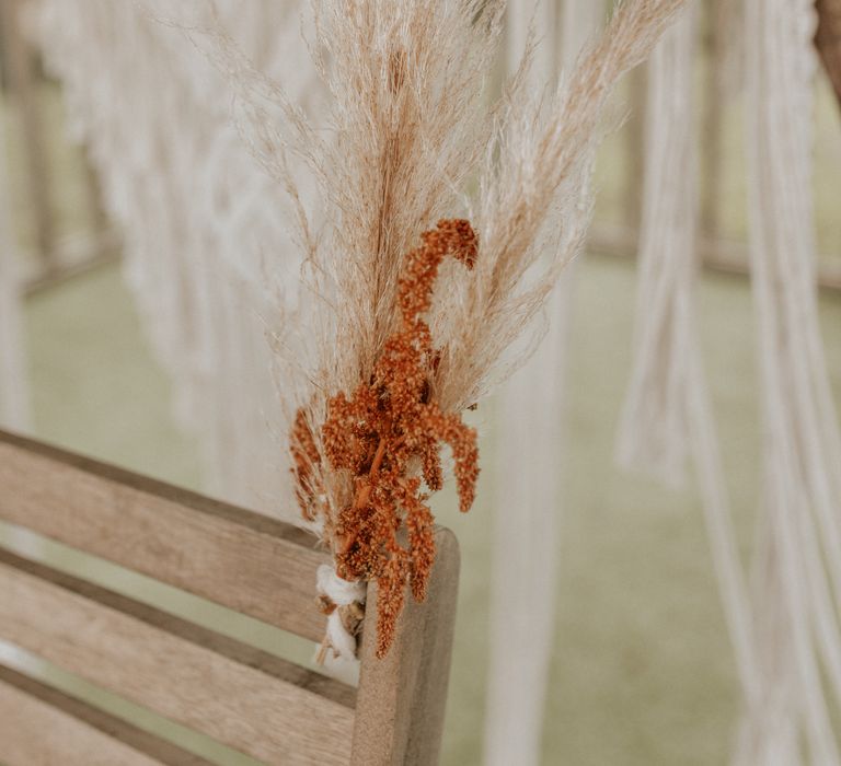 Boho floral decoration tied to wooden chair