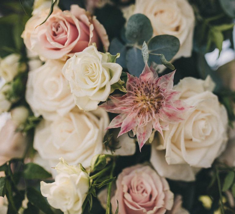 Exotic flowers were paired with classic roses for this outdoor wedding ceremony