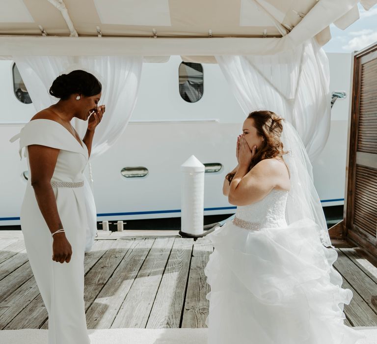 Bride and bride first look at a marina on Rhode Island 