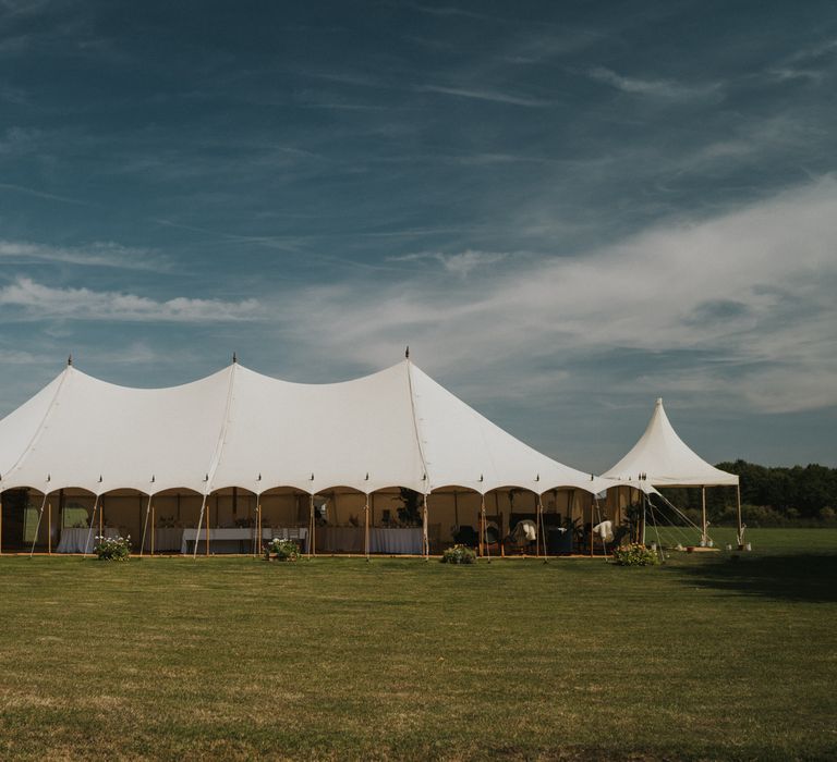 Marquee in the middle of the field with blue skies above