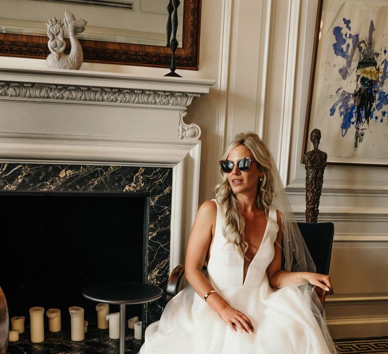 Bride wears sunglasses on the day of her wedding