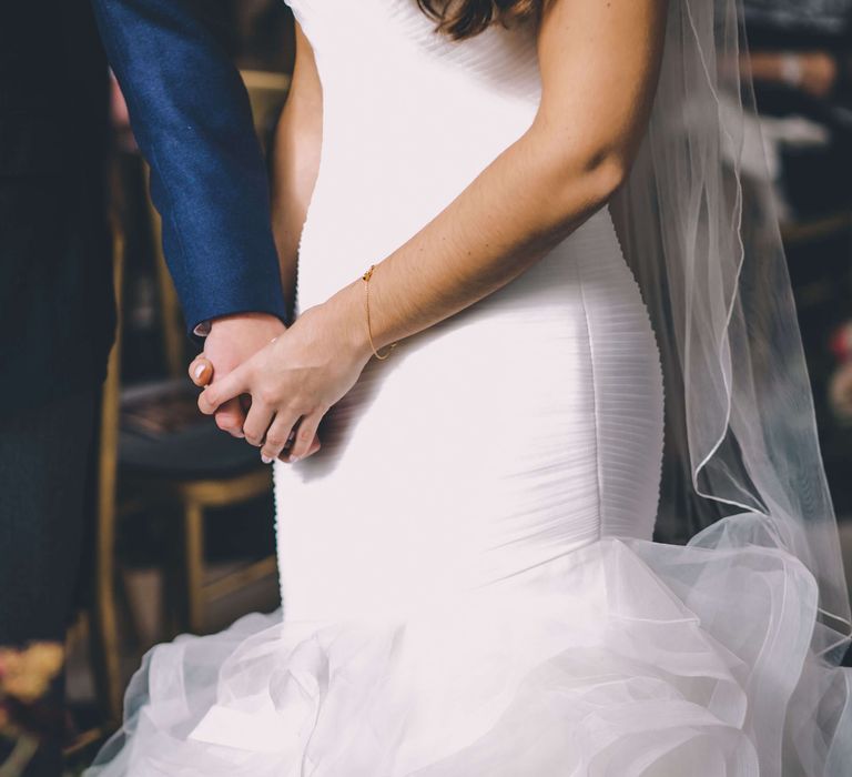 Bride and groom holding hands at London wedding